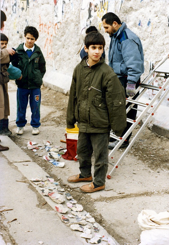 Kreuzberg children and teenagers selling pieces of the Wall as souvenirs, 1990