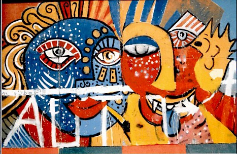 Colorful faces on the “Border Wall 75” in Berlin- Kreuzberg, between 1987 and 1989
