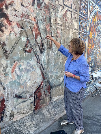 Artist Margaret Hunter repairing damaged areas of her mural as part of the conservation process in 2020